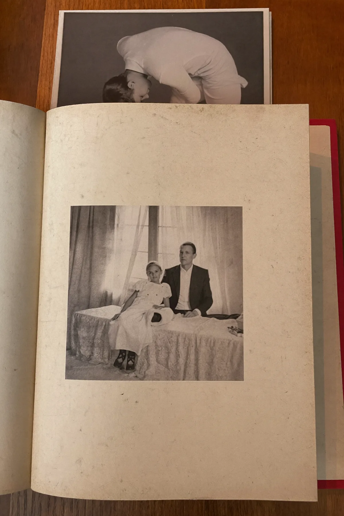An open family photo album in warm window light
